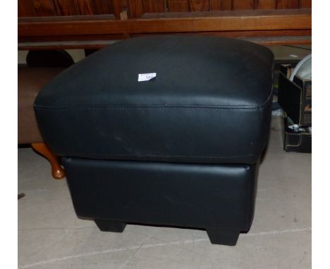 A box seat pouffe in black hide effect