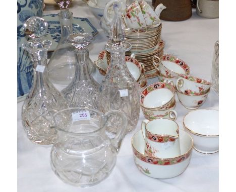 A cut crystal flat base decanter; 3 others; a jug; an early 20th century tea service