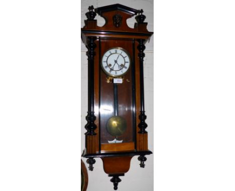 A 19th century walnut Vienna wall clock with ebonised mouldings and spring driven striking movement