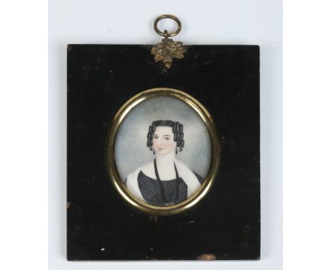 A Regency ivory portrait miniature in ebonized frame depicting a lady with ringlets in her hair. Condition Report. To be used