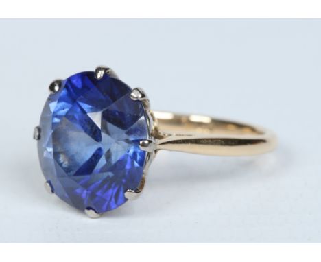 An 18 carat gold ring, claw set with a large brilliant cut sapphire approx 6 ct, ring size M. Condition Report. To be used as