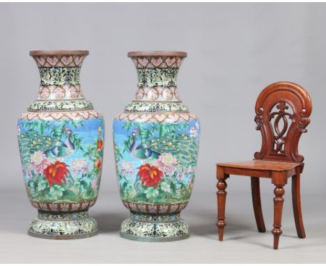 A massive pair of twentieth century Chinese cloisonne vases. Baluster in form, blue ground and decorated with a continuing la