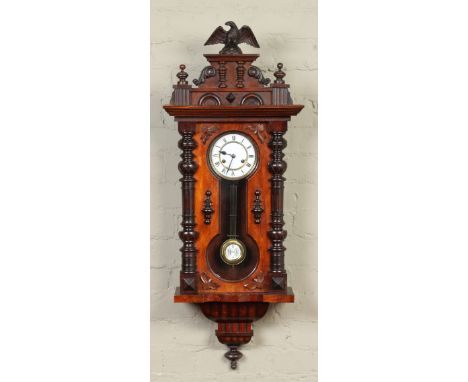 A nineteenth century Vienna wall clock housing a twin train spring driven eight day movement chiming half hourly on a gong, 1