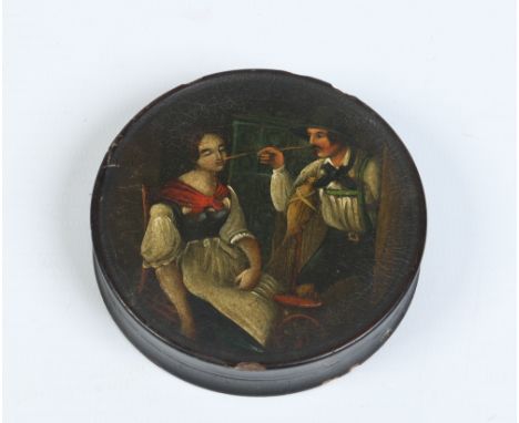 A nineteenth century ebonized papier mache circular snuff box and cover. Painted with a genre interior scene, 7.75cm diameter