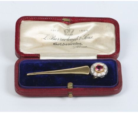An 18 carat gold comet brooch. Set with a ruby under a border of diamonds, 5.25cm. Condition Report. To be used as a guide on