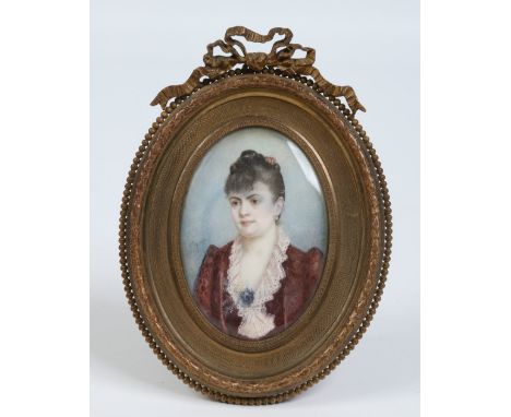 An early twentieth century portrait miniature in gilt brass strut frame. Portrait of a woman signed indistinct, 17cm. Conditi