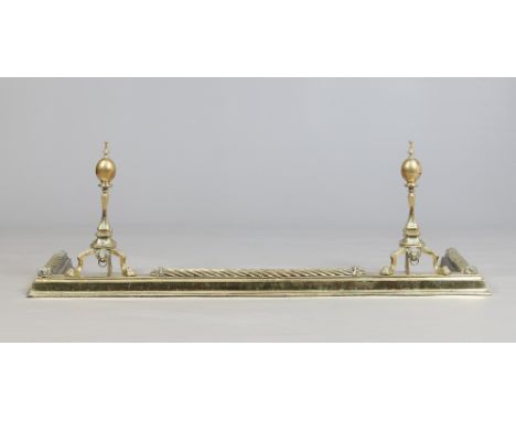 A large Victorian brass fire fender and dogs adorned with lion masks and twist mouldings, 147cm wide, 40cm deep. Condition Re