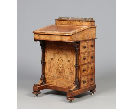 A Victorian bleached and figured walnut Davenport writing desk having maple lined interior. With brass gallery, strung inlay 
