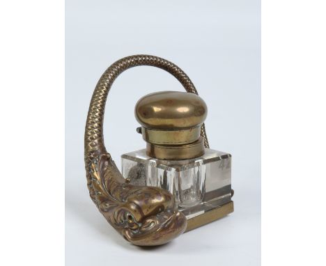 A brass and cut glass inkwell on stand surmounted by a dolphin, 10cm. Condition Report. To be used as a guide only. Chip to o