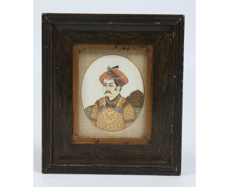 A framed Indian ivory portrait miniature of a Mogul prince. Condition Report. To be used as a guide only. Good condition.
