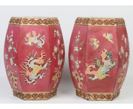 A pair of Victorian pottery hexagonal stick stands. Decorated in relief in the chinoiserie style with dragons and prunus blos