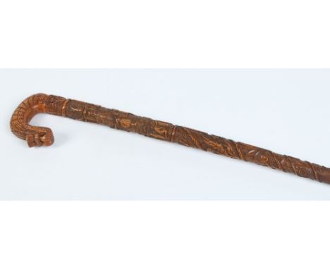 A Scottish carved folk art walking stick. With thistle motifs, figures at various pursuits and inscribed PH 1900, 91cm. Condi
