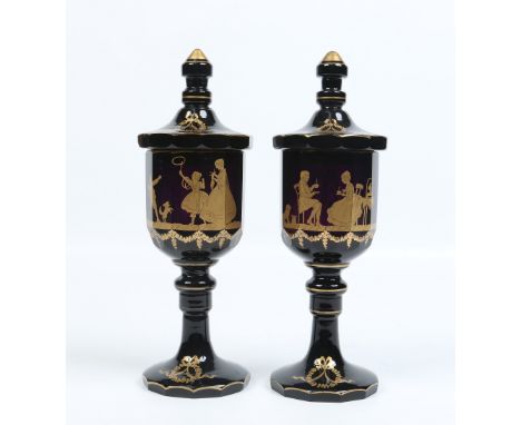A pair of antique faceted amethyst glass goblets and covers. Decorated in gilt in the manner of James Giles with figures taki