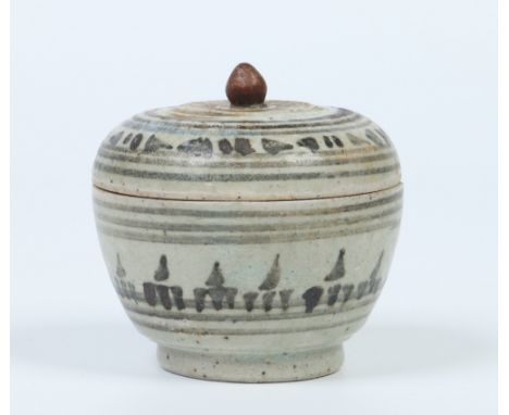 An antique Eastern lidded earthenware pot and cover decorated in underglaze blue, 9cm. Condition Report. To be used as a guid