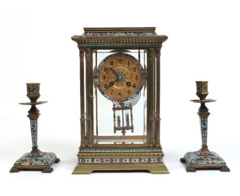 A nineteenth century French assembled clock garniture with pale blue ground champleve enamel decoration. The four glass clock
