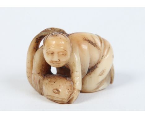 A Japanese carved ivory netsuke. Formed as a man wrestling with a large fish, 4cm. Condition Report. To be used as a guide on