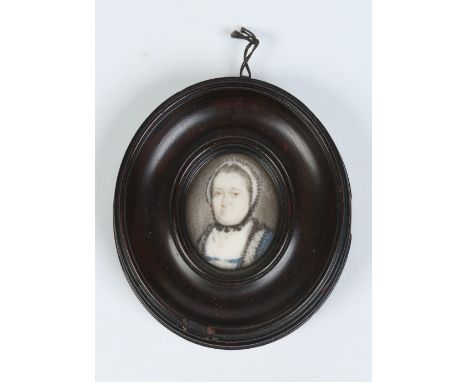A small nineteenth century ivory portrait miniature of an older woman in carved wooden frame. Condition Report. To be used as