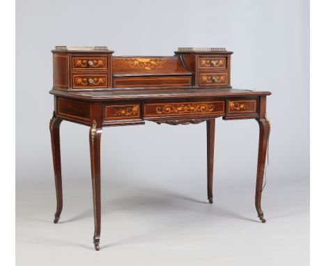 A Victorian rosewood ladies writing desk by James Shoolbred & Co. With brass gallery rails, marquetry inlay and raised on squ
