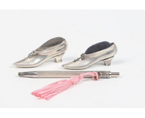 A novelty silver pin cushion formed as a shoe, assayed London 1988, a similar white metal pin cushion and a sterling silver p