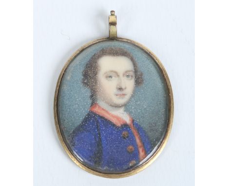 A Georgian pendant set with a portrait miniature of a gentleman wearing a blue overcoat with red collar. Monogrammed G. S. sc
