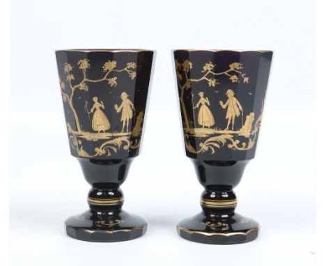A pair of antique faceted amethyst glass goblets with gilt decoration in the manner of James Giles with courting couples over
