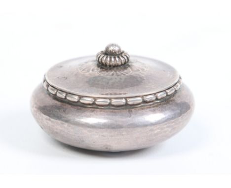 A Georg Jensen Danish silver planished miniature bowl and cover with stylized finial. Import marks for London 1924, 6.25cm di