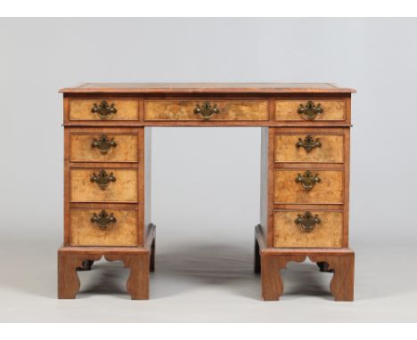 An early twentieth century walnut twin pedestal leather topped desk raised on bracket feet, 102cm wide. Condition Report. To 