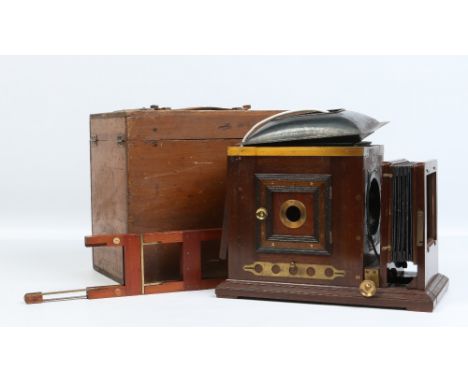 A Victorian brass and mahogany magic lantern in tin case converted to electricity.