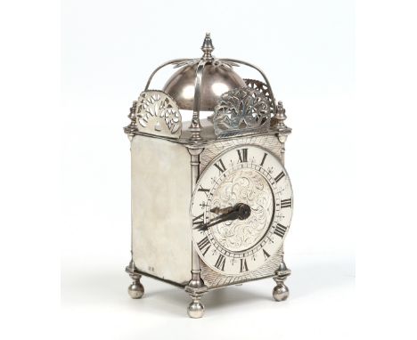 An Edwardian silver cased lantern clock housing a single train thirty hour movement. Assayed Birmingham 1906, 16cm. Condition