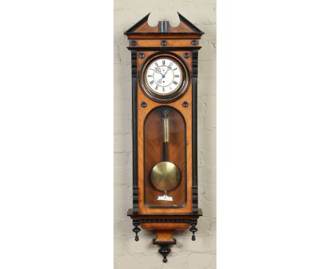 A nineteenth century walnut single weight Vienna wall clock. With ebonized mouldings and enamel dial with subsidiary seconds,