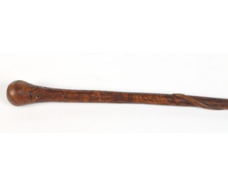 A nineteenth century folk art walking cane. Carved with a serpent and with all over penwork decoration inscribed R. E. 1850 a