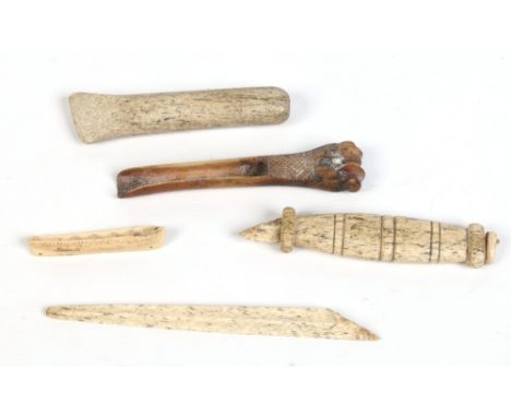 Three Inuit carved tools including marine ivory examples and a small model of a boat. Largest 30cm. Condition Report. To be u