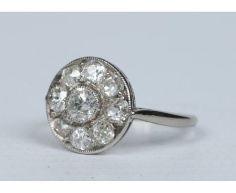 An Art Deco white gold diamond cluster ring with nine old European cut stones in a segmented milgrain setting approx 0.75ct t