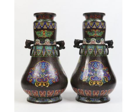 A large pair of Chinese cloisonne baluster shaped vases. With twin mask and loop handles and decorated over black fret ground