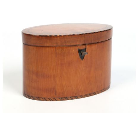 A Regency oval satinwood tea caddy. With cross hatched inlay, stringing and shield escutcheon, 19cm wide. Condition Report. T