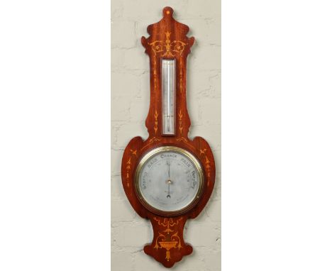 A late Victorian mahogany barometer by Dollond of London. Wth silvered dial and marquetry inlay, 86cm. Condition Report. To b