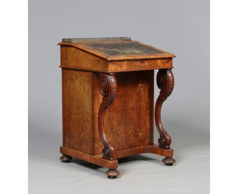 A Victorian burr walnut and marquetry davenport writing desk. With brass gallery and carved double scrolling supports, 85cm. 