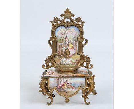 An early twentieth century French gilt metal and enamel encrier. Formed as a rococo dressing table and decorated with eightee
