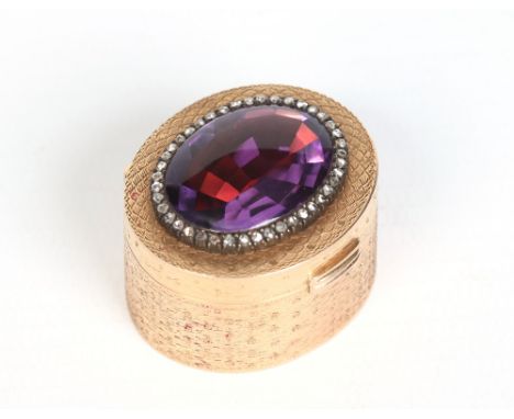 A fine Continental gold pill box. Set to the cover with a large ovoid half cabochon half faceted amethyst under a rose diamon