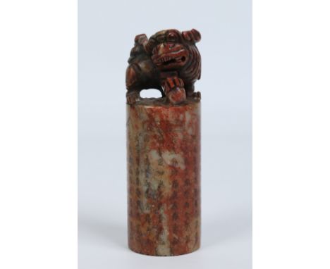 A Chinese cylidrical carved soapstone seal. With a dog of fo capital, incised poem inscription and landscape scene. Roundel p