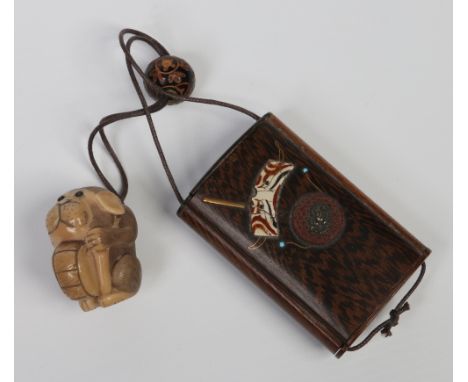 A Japanese carved horn netsuke formed as a puppy holding a drum, along with a Shibayama inlaid wooden inro and carved ojime. 