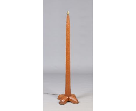 An adzed oak standard lamp by Stanley Webb Davies of Windermere (1894-1978). Tapering form and raised on a cross shaped base.