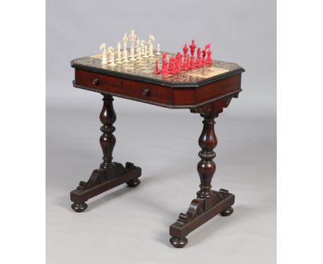 A very fine Regency rosewood twin pedestal chess table and accompanying carved ivory chess set in the single fitted drawer. T