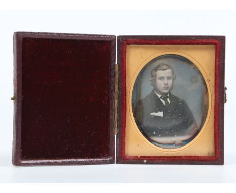 A Victorian daguerreotype in gilt mount and fitted leather case. Portrait of a young gentleman, 7.25cm. Condition Report. To 