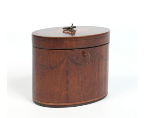 A small Regency oval mahogany tea caddy. With brass loop handle, banded in rosewood and with a marquetry inlaid motif to the 