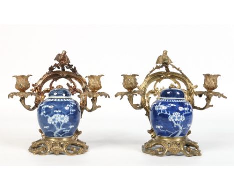 A pair of nineteenth century French ormolu mounted Chinese perfumiers. Painted in underglaze blue with prunus blossom and the