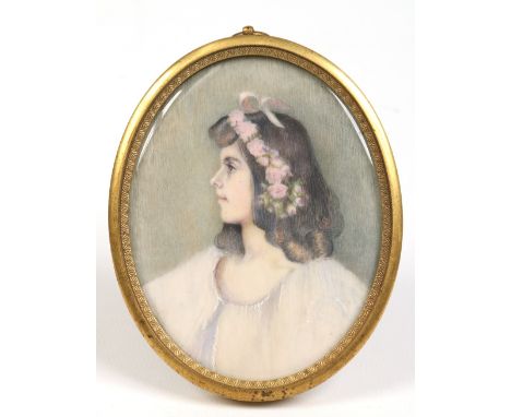 An early twentieth century oval ivory portrait miniature of a young girl in brass strut frame, 10cm. Condition Report. To be 