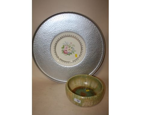 A RUSKIN POTTERY STYLE BOWL TOGETHER WITH A FLORAL LIMOGES PLATE IN METAL SURROUND, OVERALL DIAMETER 50 CM