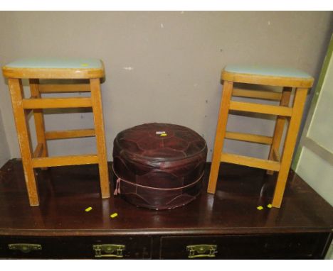 A VINTAGE RED POUFFE AND TWO UTILITY TYPE STOOLS (3)