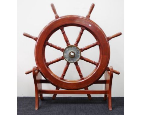 Vintage ships steering wheel from a helm. with 8 spokes and a brass hub
